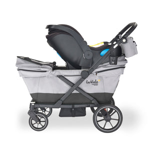 car seat installed on the caravan coupe quad 4-seater stroller wagon in gray with a black stripe at the bottom