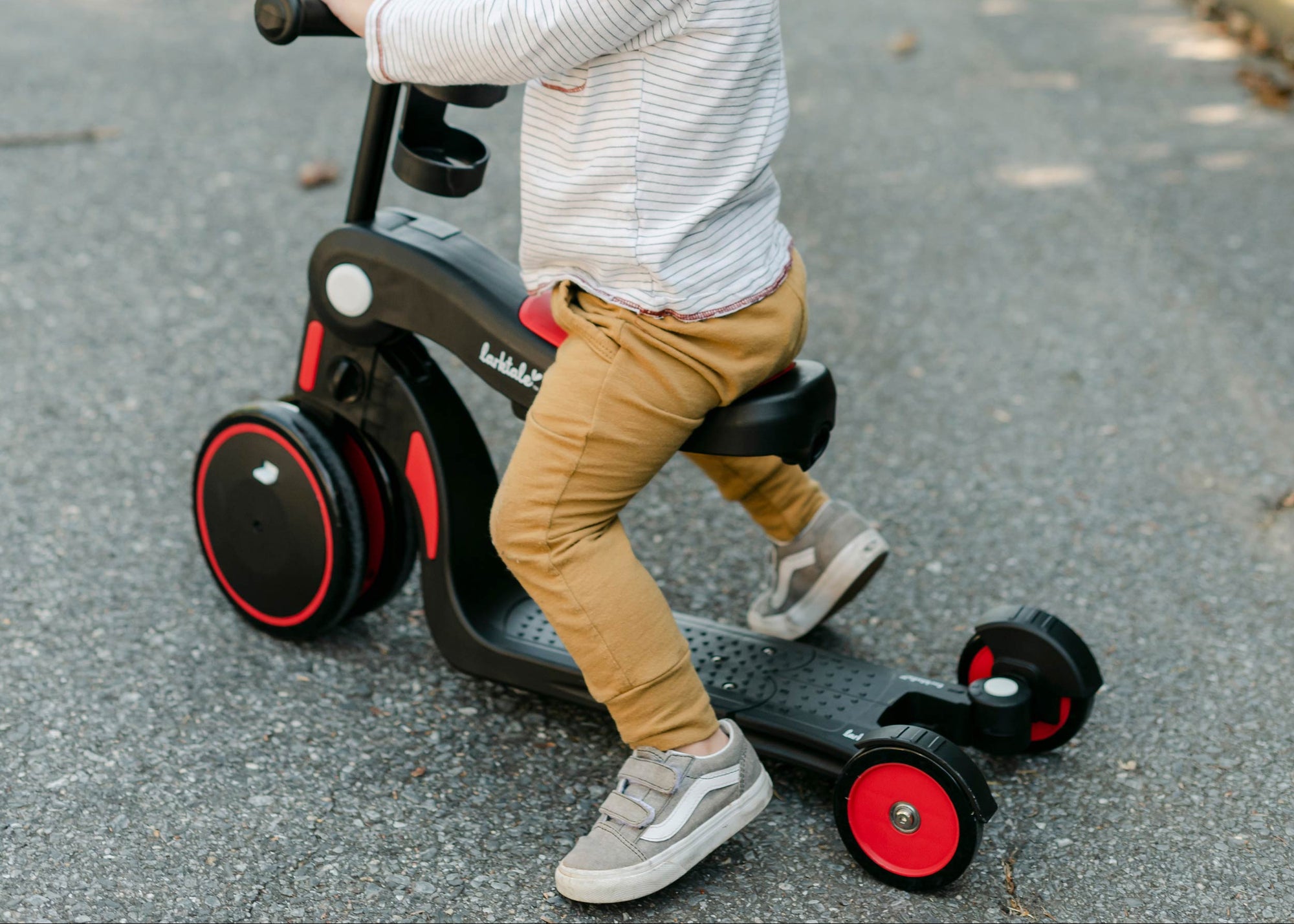 Toddler boy sits on the scoobi scooter in ride-on mode