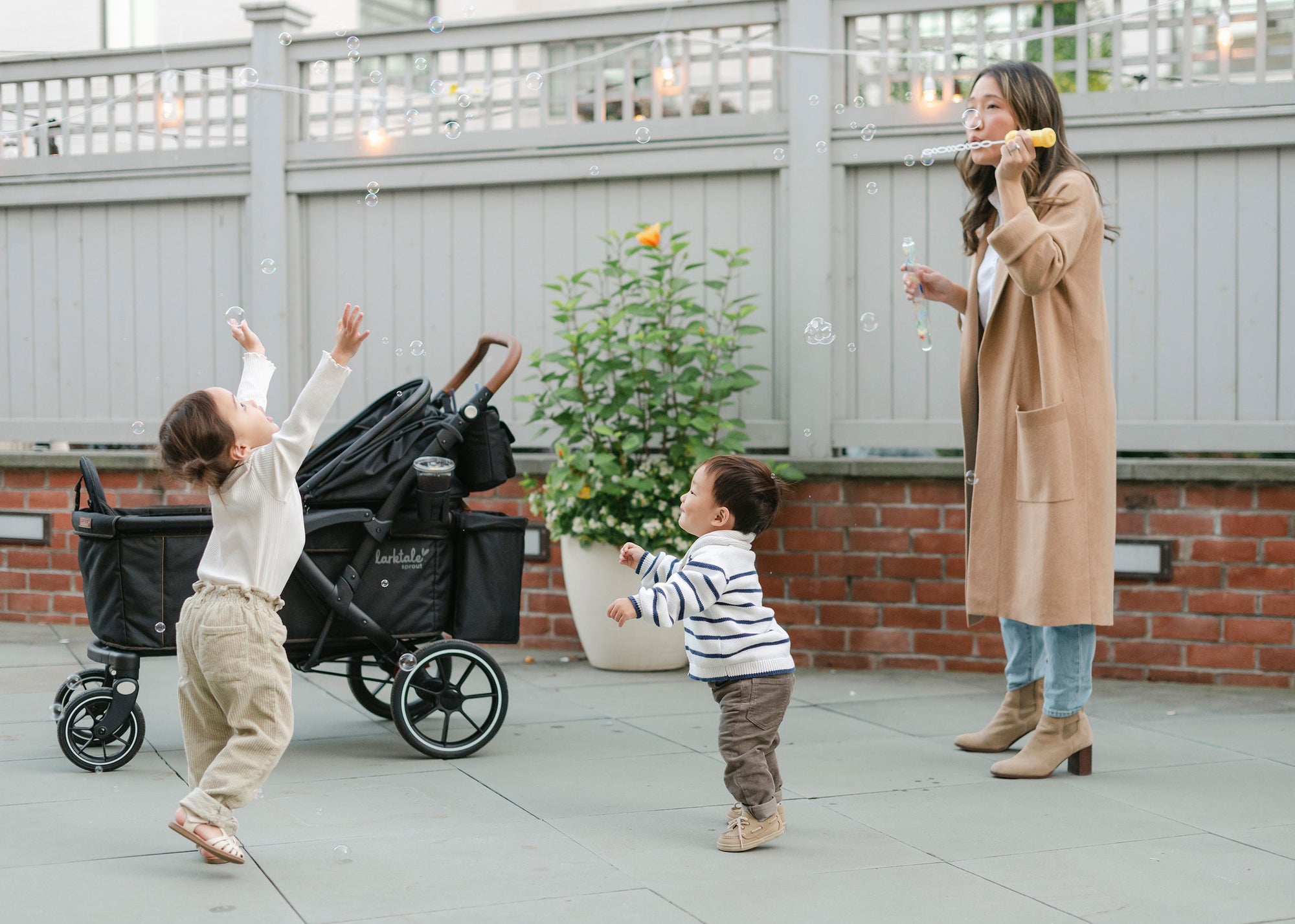 kids playing with bubbles with the Larktale sprout in the background