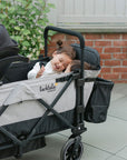 children using the caravan double seat kit with the infant car seat attached to the wagon