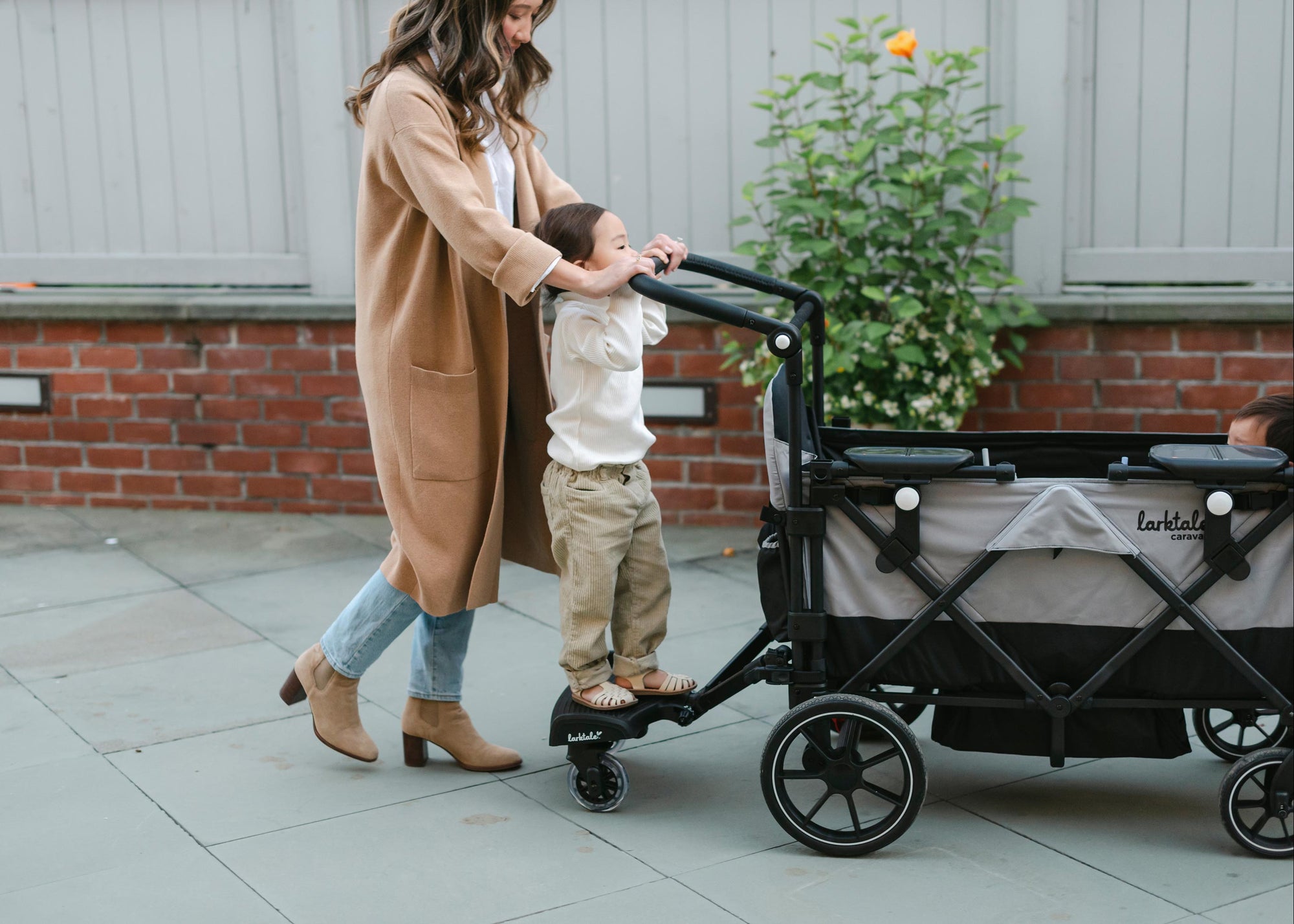 kid standing on the troller board connected to the caravan