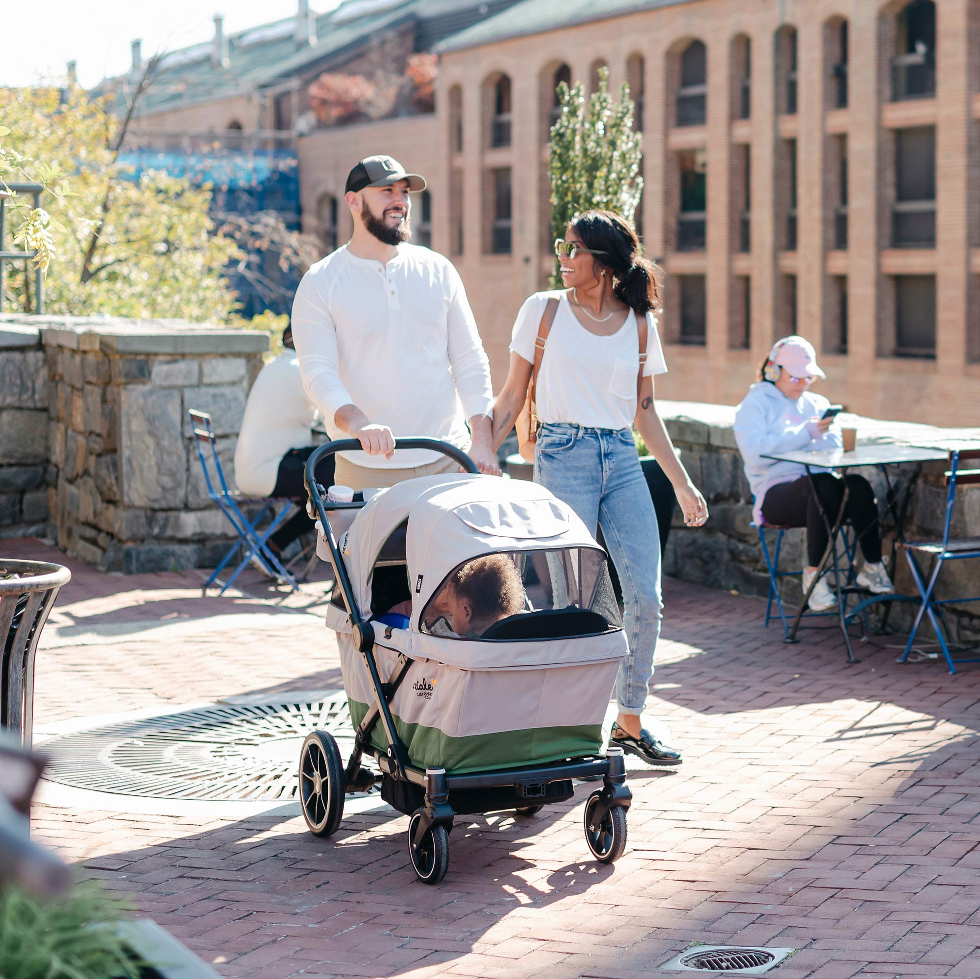 family strolling on the sidewalk with the caravan coupe 