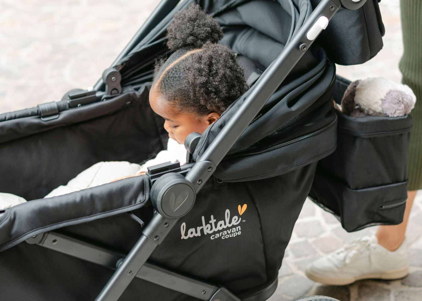child in byron black caravan coupe with seat reclined