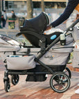 lifestyle image of car seat installed on the caravan coupe quad 4-seater stroller wagon