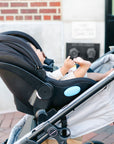 baby in car seat attached to crossover stroller/wagon