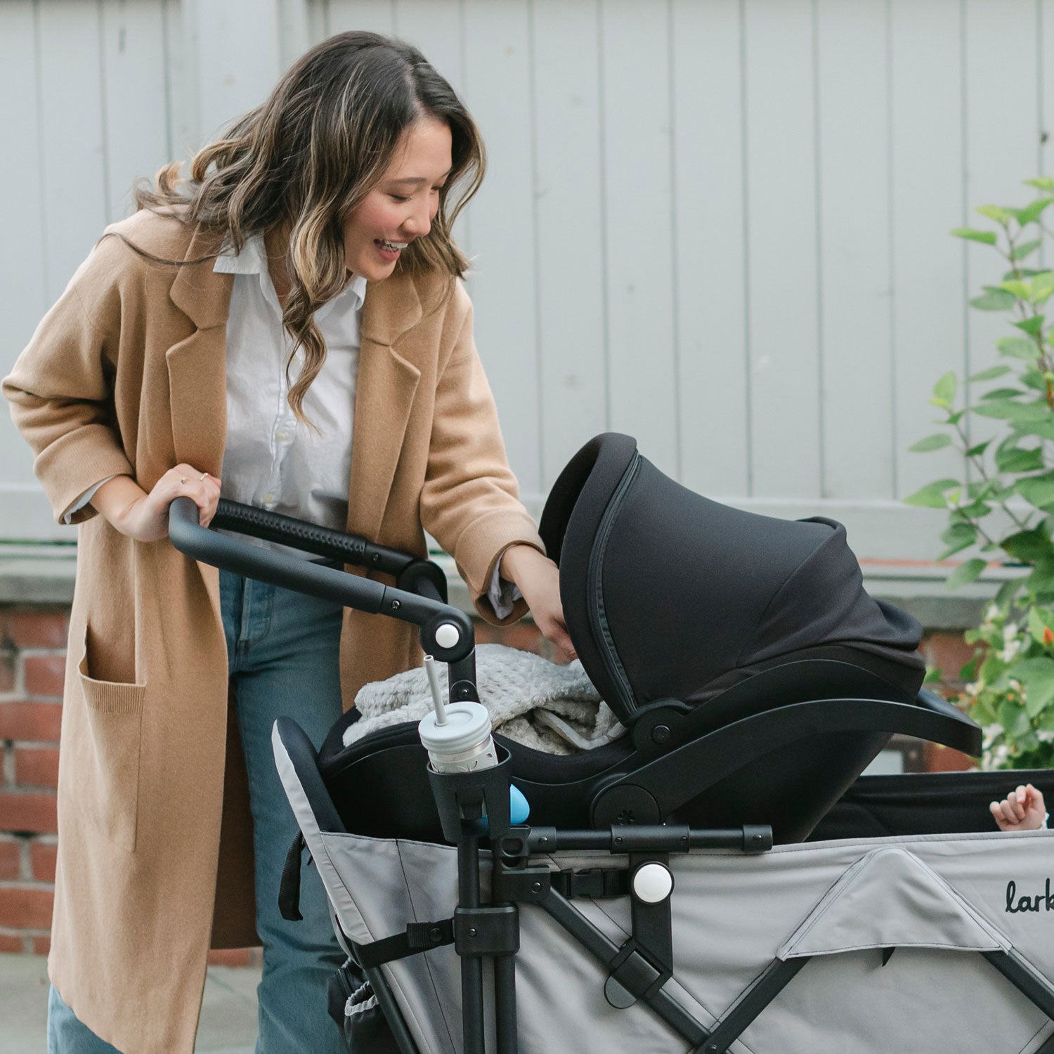 mother using the caravan with infant car seat attached