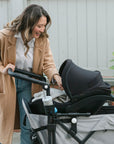 mother using the caravan with infant car seat attached